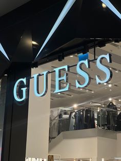 a guess store with clothes on display in the window