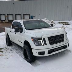 a white truck is parked in the snow