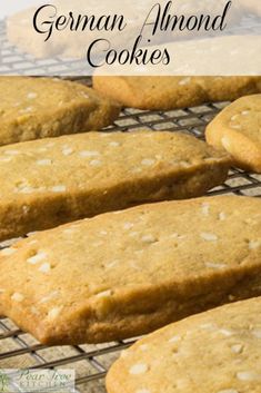 cookies cooling on a wire rack with the words german almond cookies above it in front of them