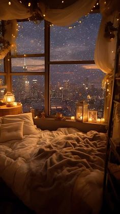 a bedroom with a view of the city at night