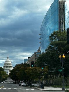 the capitol building in washington d c is seen from across the street with traffic lights