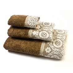 three brown towels with white lace on them