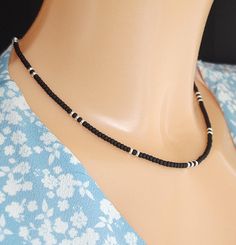 Stunning black and sterling silver bead necklace. Matte black Miyuki beads with 925 silver highlights repeating  pattern. 925 sterling silver clasp and extender chain. 16 inches in length with a 2 inch extension. Classic, minimalist necklace. Compliments many outfits. Great for casual wear or formal occasions. Gift for women wives birthday.  * 16" length with 2" extender chain, 3mm width. * 925 sterling silver components and beads. * Miyuki beads - High quality Japanese glass beads renowned acro Minimalist Black Beaded Choker Necklace, Black Sterling Silver Choker For Gift, Black Sterling Silver Choker As Gift, Minimalist Black Jewelry With Sterling Silver Clasp, Black Sterling Silver Necklace With Silver Beads, Minimalist Silver Beaded Necklace With Black Beads, Black Necklace With Sterling Silver Clasp, Black Sterling Silver Necklace With Silver Clasp, Minimalist Silver Necklace With Black Beads