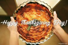 a person holding a pie in their hands with a sprig of rosemary on top