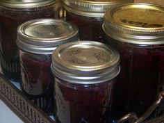 several jars filled with jam sitting on top of a counter