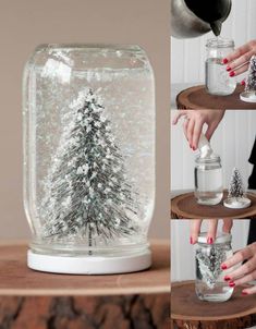 the snow globe is filled with silver glitter and has a pine tree in it as well