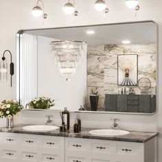 a bathroom with two sinks and a large mirror over it's counter top area