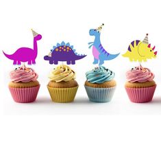 three cupcakes with colorful frosting and dinosaur toppers in front of white background