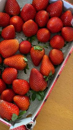 a box filled with lots of ripe strawberries