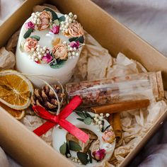 an open box with candles, orange slices and other items