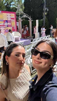 two women taking a selfie at an outdoor event