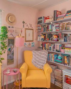 a yellow chair sitting in front of a book shelf filled with books