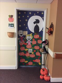 a door decorated with halloween decorations and pumpkins