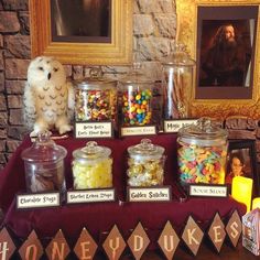 a table topped with jars filled with candy