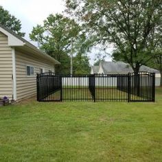 a black fence in front of a house