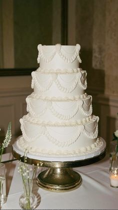 a white wedding cake sitting on top of a table