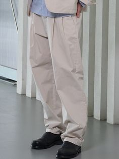 This is a minimal and comfortable pants made out of high quality cotton, polyester, and rayon blend fabric. With minimal design detail of adjustable belt on the waistband, tuck detail for wide silhouette, and back welt pockets, it gives a modern and refined mood to your look.- Welt pockets on the back- Adjustable belt on the waistband- Double tuck on the front- Set up with matching jacket Relaxed Fit Solid Color Chinos With Belt Loops, Relaxed Fit Cotton Belted Bottoms, Casual Relaxed Fit Belted Bottoms, Belted Straight Cotton Pants, Belted Relaxed Fit Cotton Bottoms, Belted Cotton Bottoms With Relaxed Fit, Belted Beige Cotton Bottoms, Beige Belted Cotton Bottoms, Relaxed Fit Chinos With Belt Loops