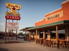 the outside of a restaurant with tables and chairs