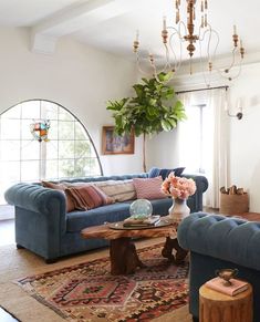 a living room with blue couches and rugs