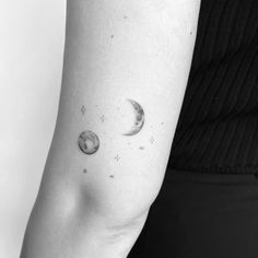 a woman's arm with the moon and stars on it