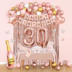 a pink and gold 30th birthday party with balloons