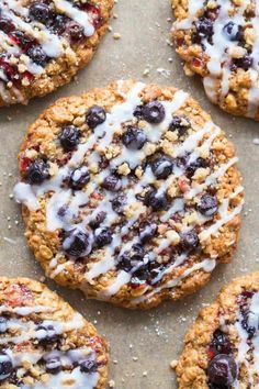 blueberry oatmeal cookies with white icing on a baking sheet ready to be eaten