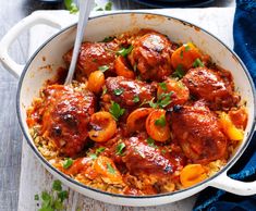 two bowls filled with meatballs and rice on top of a wooden table next to blue napkins