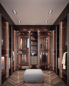 a large walk in closet with lots of clothes