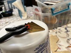 a pair of pliers resting on top of a white container