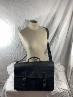 Measurements are 17" wide, 11"5 high, 4"7 deep with a 56 "shoulder strap with a 24" drop. On the interior there are two main compartments, unlined interior, two front pockets under flap with buckle like closures. The leather is nice and strong with light stitching, top handle, aged gold tone hardware, detachable shoulder strap and brief can be used crossbody.  This bag is great for work, school and travel and is spacious. 100% Roots made in Canada and is in very good condition for its age.  Item Classic Flap Shoulder Bag For School, Classic Crossbody Saddle Bag For School, Business Satchel Saddle Bag, Classic Rectangular Saddle Bag For School, Classic Saddle Bag For School, Classic Shoulder Saddle Bag For School, Classic School Satchel With Leather Backing, Leather Flap Briefcase For Formal Use, Vintage Briefcase For Business Trips