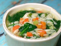 a white bowl filled with soup on top of a blue table