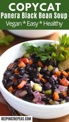 a white bowl filled with black beans and vegetables