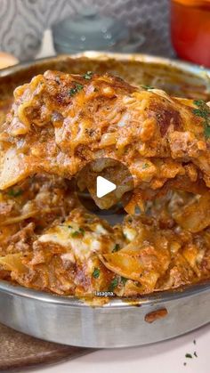 a metal pan filled with food on top of a table