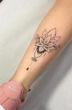 a woman's arm with a flower tattoo on it