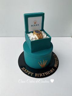 a birthday cake with a rolex watch in it