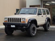 a white jeep parked in front of a building