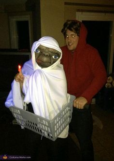 a man in a costume holding a basket with a dog dressed as a nun on it