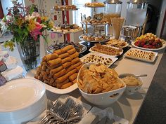 a buffet table filled with lots of different foods and desserts on top of it