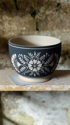 a black and white bowl sitting on top of a counter