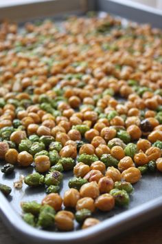 peas and chickpeas on a baking sheet ready to be cooked in the oven