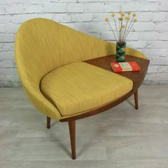 an orange couch sitting on top of a wooden table