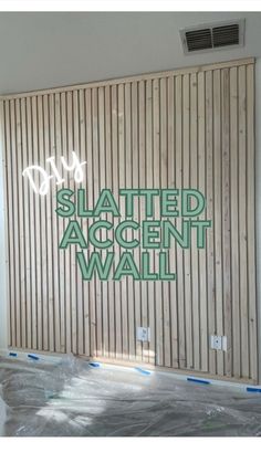 a sign that reads slanted accent wall in front of a wooden slatted wall