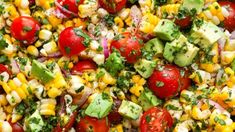 corn salad with tomatoes, avocado, and cilantro on the side