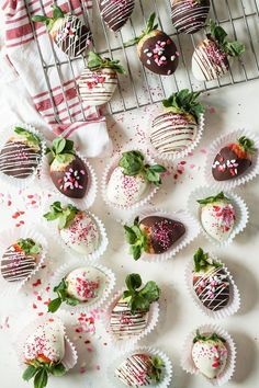 chocolate covered strawberries with sprinkles on a cooling rack next to them