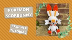 a crocheted stuffed animal sitting next to a brick wall with the words pokemon scorbunny on it