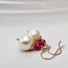 Pearl and and ruby earrings with genuine stones, the creamy white pearl is paired with a small ruby and hung on 14k gold filled wires. The creamy white pearls are hand drilled, and paired are light weight  These come with silicone backs. . Medium Pearls - 8x10mm  (medium) Pearls - 7 x 6mm  (small) Arrives gift wrapped Elegant White Ruby Earrings, Briolette Pearl Earrings With Gemstone For Gift, Elegant Pearl Birthstone Earrings As Gift, Elegant Pearl Birthstone Earrings For Gift, Elegant Birthstone Pearl Earrings As Gift, Ruby And Pearl, 2022 Jewelry, Ruby Earrings, Rose Gold Jewelry