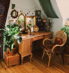 a wooden desk topped with a plant next to a mirror