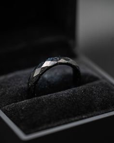 a black and white diamond ring in a box