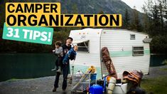 a man holding a child in front of a camper with the words camper organization 31 tips