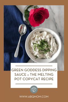 green goddess dipping sauce in a white bowl next to a red rose and spoon